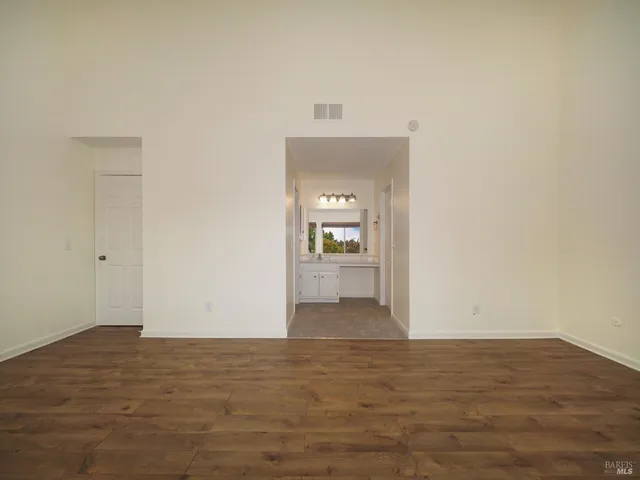 a view of a room with wooden floor and cabinet