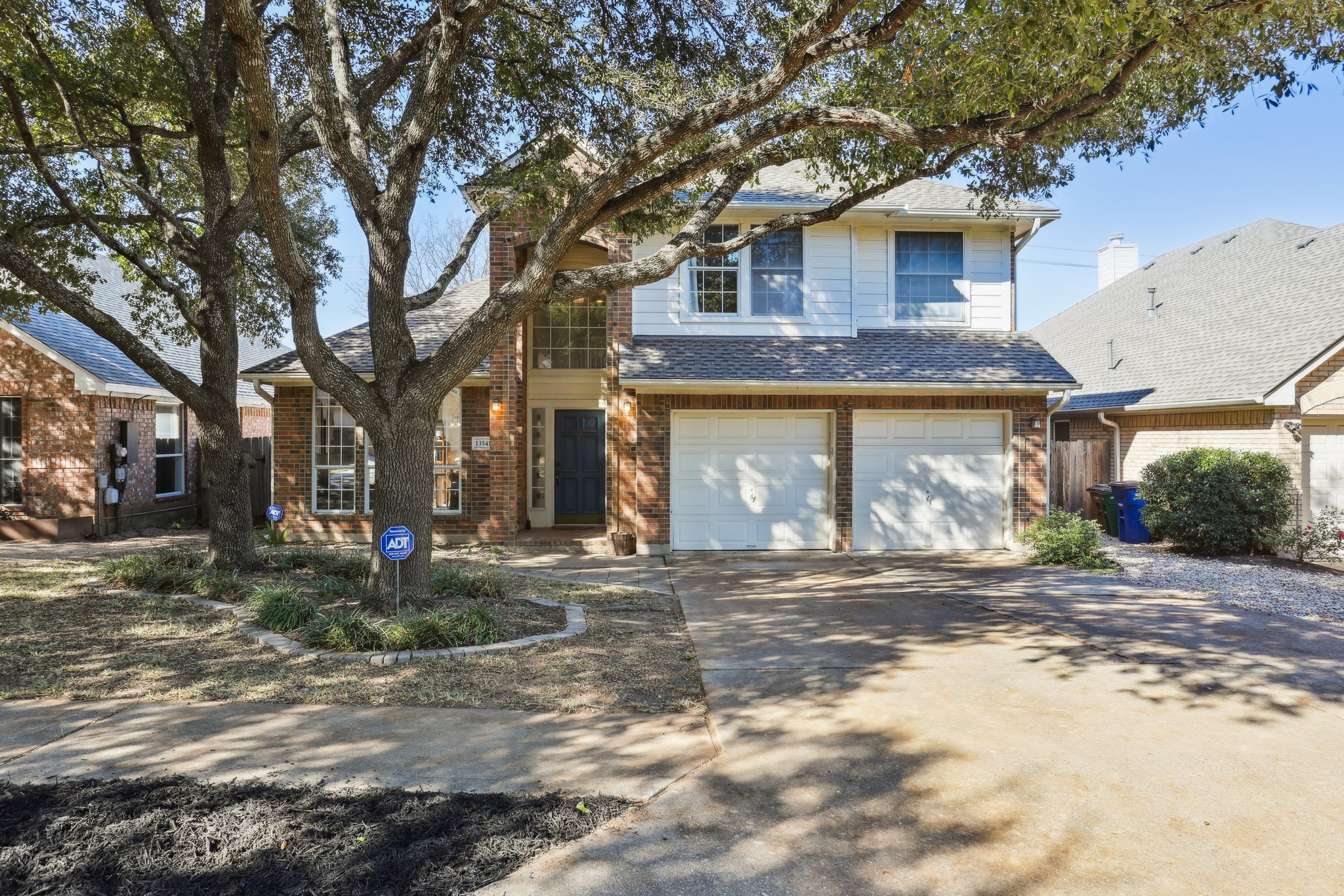 13541 Anarosa Loop Austin, TX 78727 - Photo 25 of 27 Two-story brick and siding residence featuring a prominent mature tree canopy