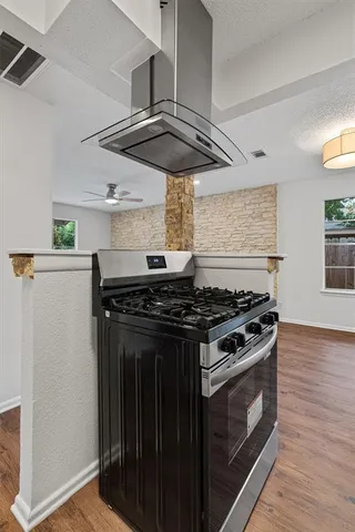 a stove top oven sitting inside of a kitchen