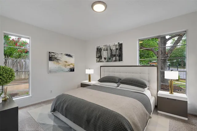 a bedroom with a large bed and a potted plant