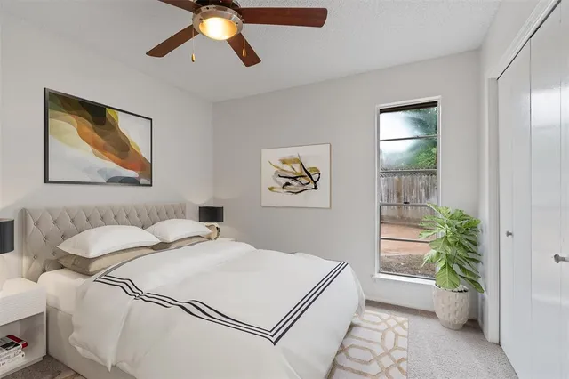 a bedroom with a bed and a painting on the wall