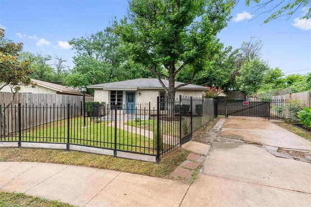 a view of a house with a backyard and a patio