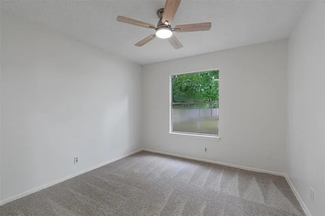 a bathroom with a granite countertop toilet sink and mirror