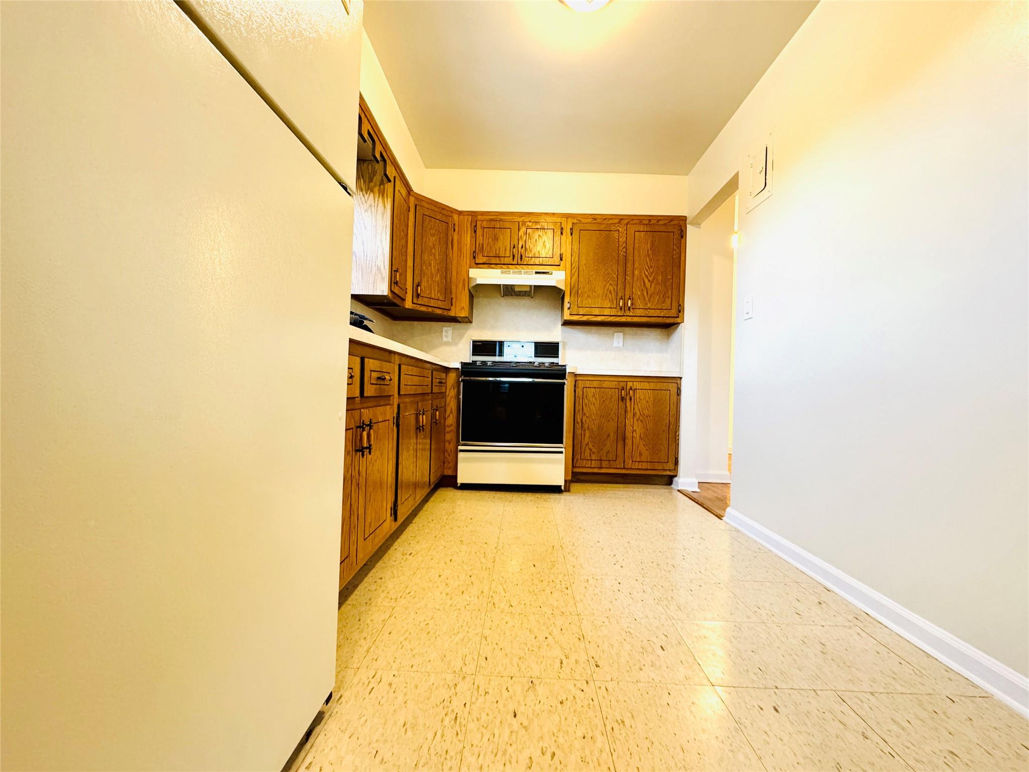 41-07 56th Street, Unit 3 Queens, NY 11377 - Photo 3 of 13 a view of a kitchen with a sink and cabinets