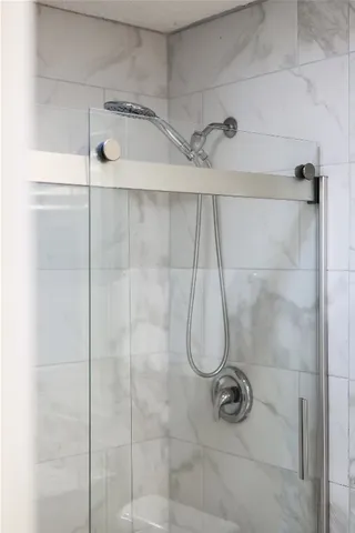 a bathroom with a glass shower door