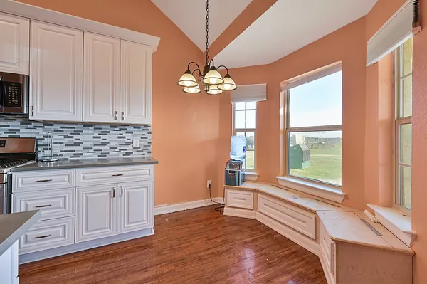 a kitchen with a white cabinets and window