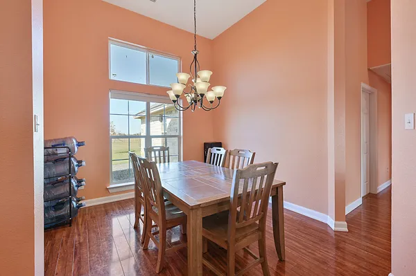 a dining room with furniture potted plants and wooden floor