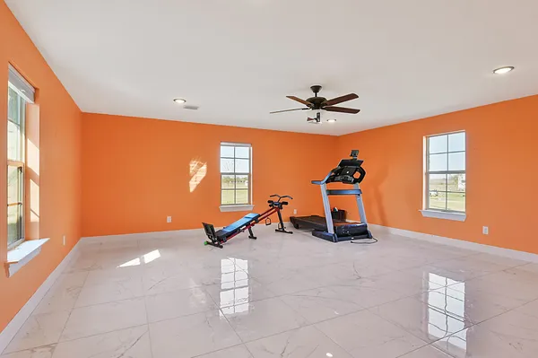 a room with gym equipment and windows