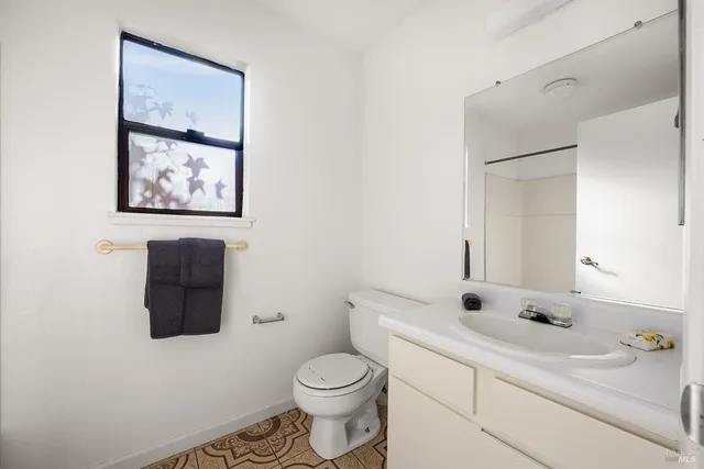 a bathroom with a toilet sink and mirror