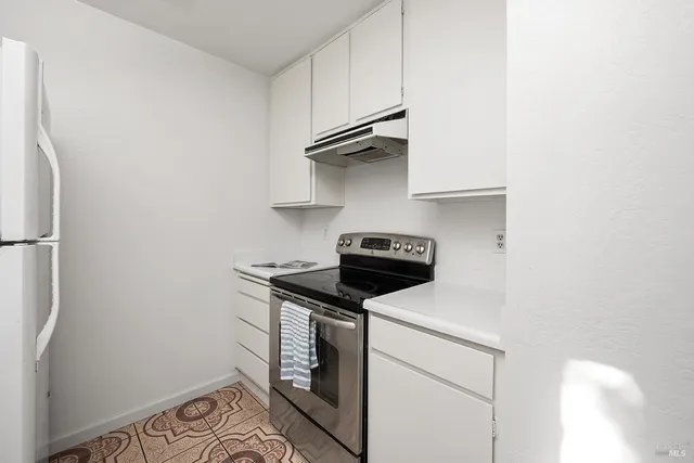 a kitchen with stainless steel appliances a stove and a refrigerator