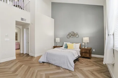 a bedroom with a bed and a lamp on table