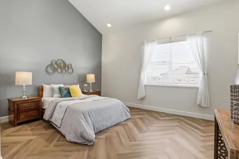 a bedroom with a bed and a window