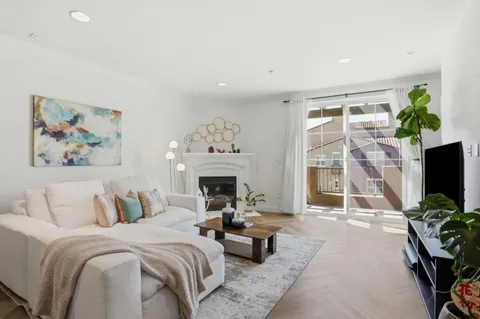 a spacious bedroom with a bed and a flat screen tv