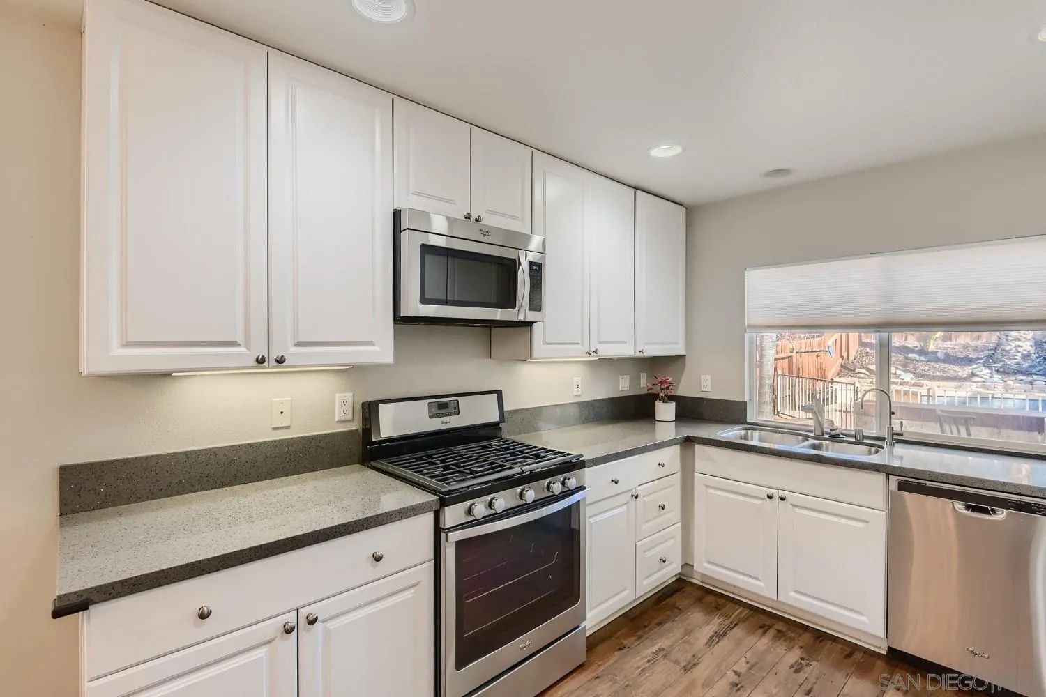 39538 Oak Circle Murrieta, CA 92563 - Photo 11 of 27 a kitchen with granite countertop white cabinets white stainless steel appliances and a sink