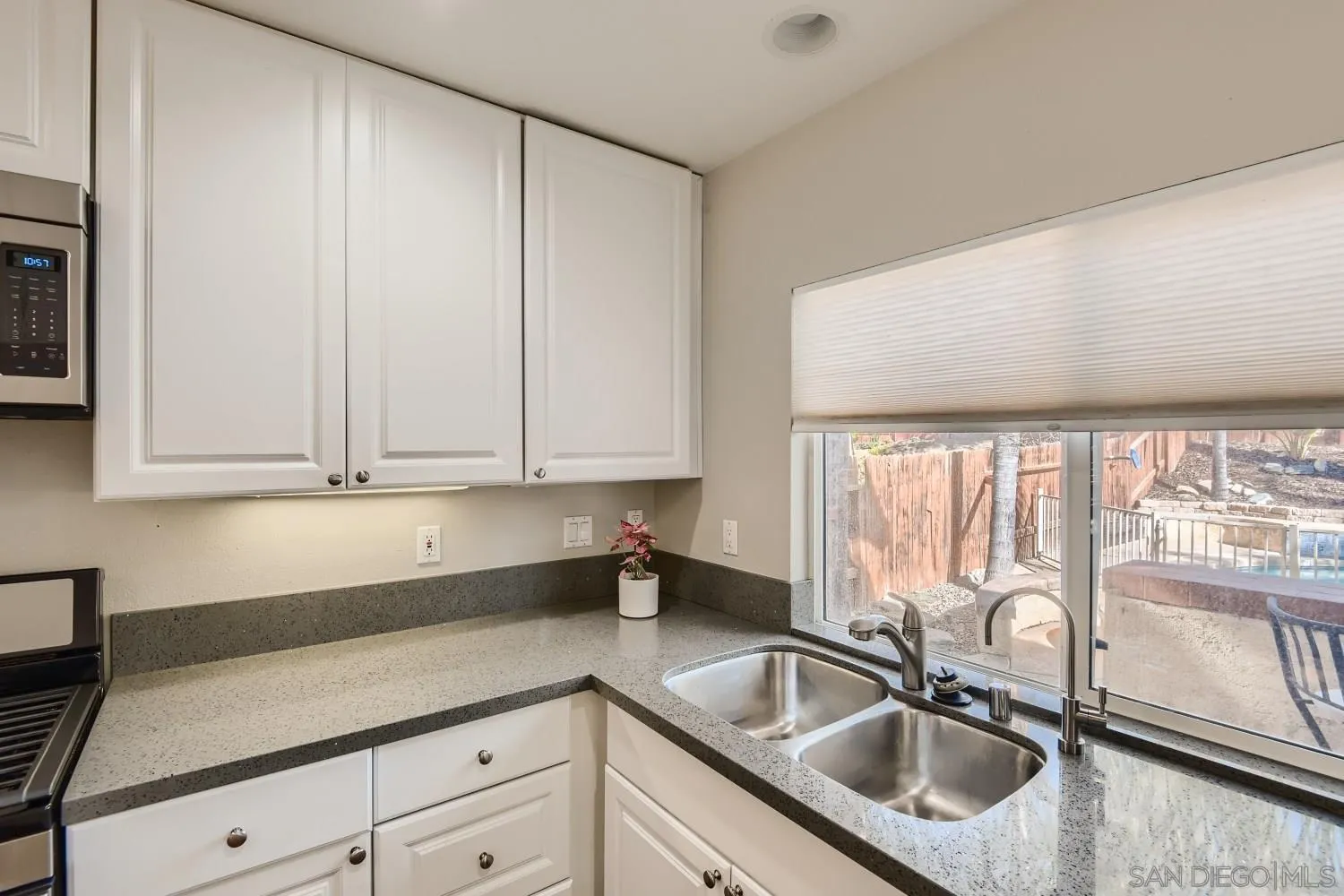 39538 Oak Circle Murrieta, CA 92563 - Photo 12 of 27 a kitchen with granite countertop a sink window and cabinets
