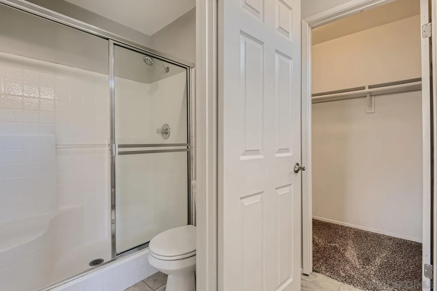 39538 Oak Circle Murrieta, CA 92563 - Photo 19 of 27 a bathroom with a glass shower door