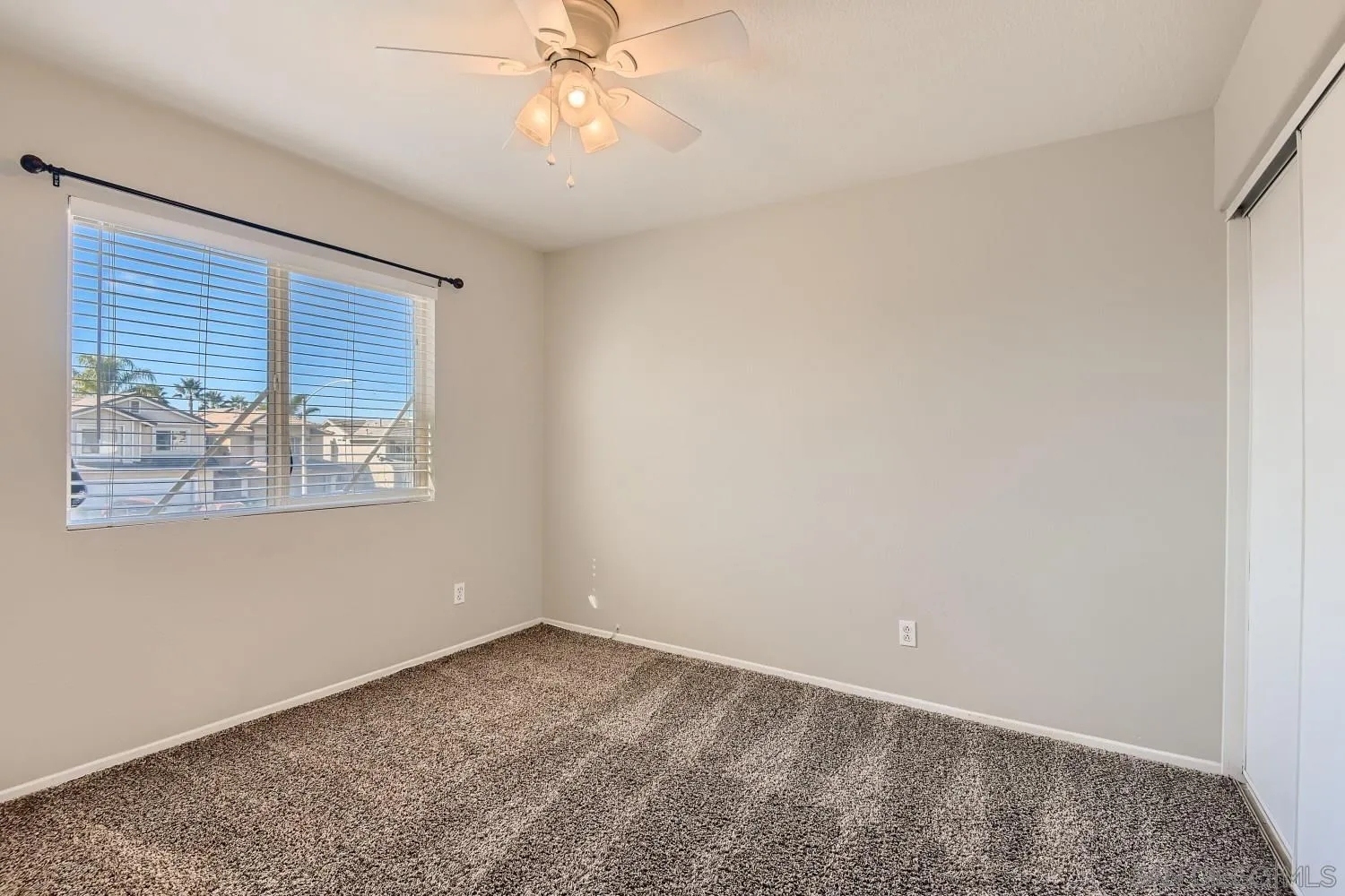 39538 Oak Circle Murrieta, CA 92563 - Photo 21 of 27 an empty room with windows and fan