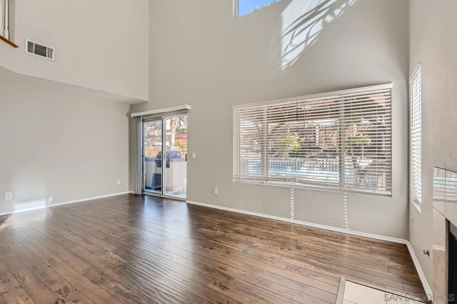39538 Oak Circle Murrieta, CA 92563 - Photo 6 of 27 a view of an empty room with wooden floor and a window