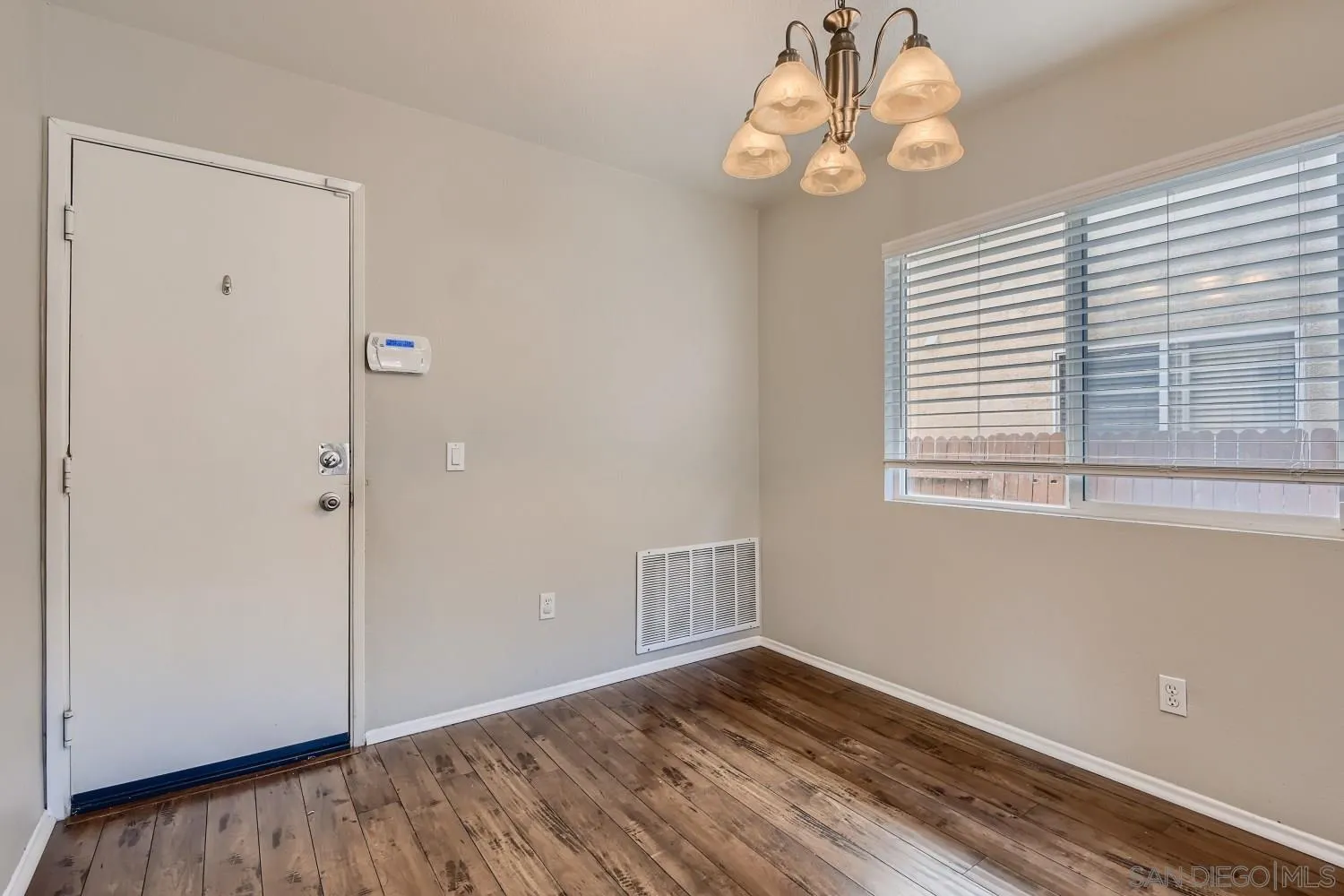 39538 Oak Circle Murrieta, CA 92563 - Photo 9 of 27 a view of an empty room with wooden floor and a window
