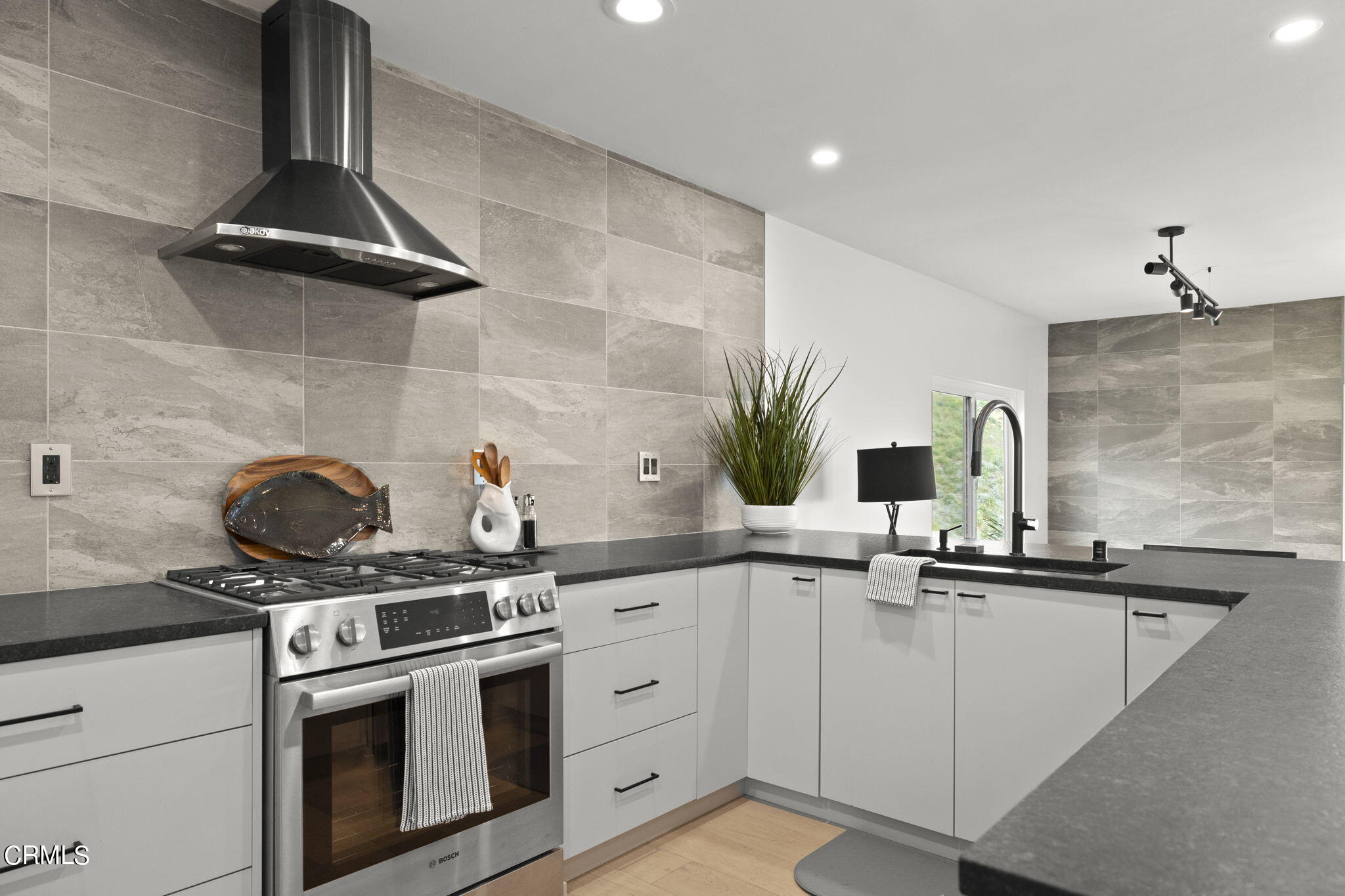 940 Vallecito Drive Ventura, CA 93001 - Photo 12 of 42 a kitchen with stainless steel appliances a sink stove and cabinets