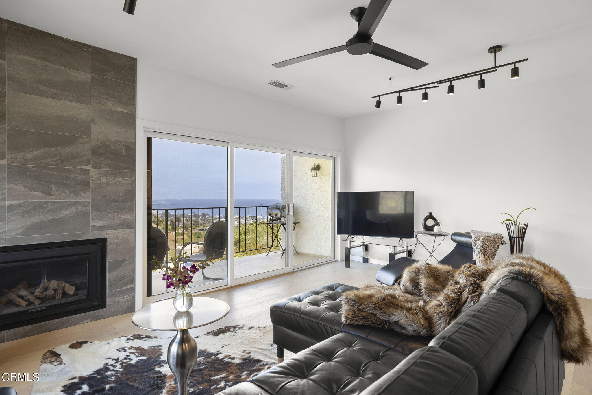 940 Vallecito Drive Ventura, CA 93001 - Photo 18 of 42 a living room with furniture a large window and a fireplace
