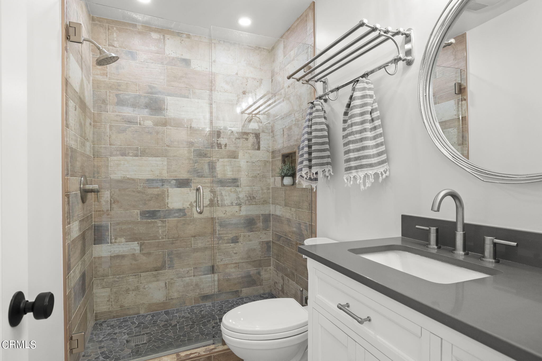 940 Vallecito Drive Ventura, CA 93001 - Photo 23 of 42 a bathroom with a sink a toilet and shower