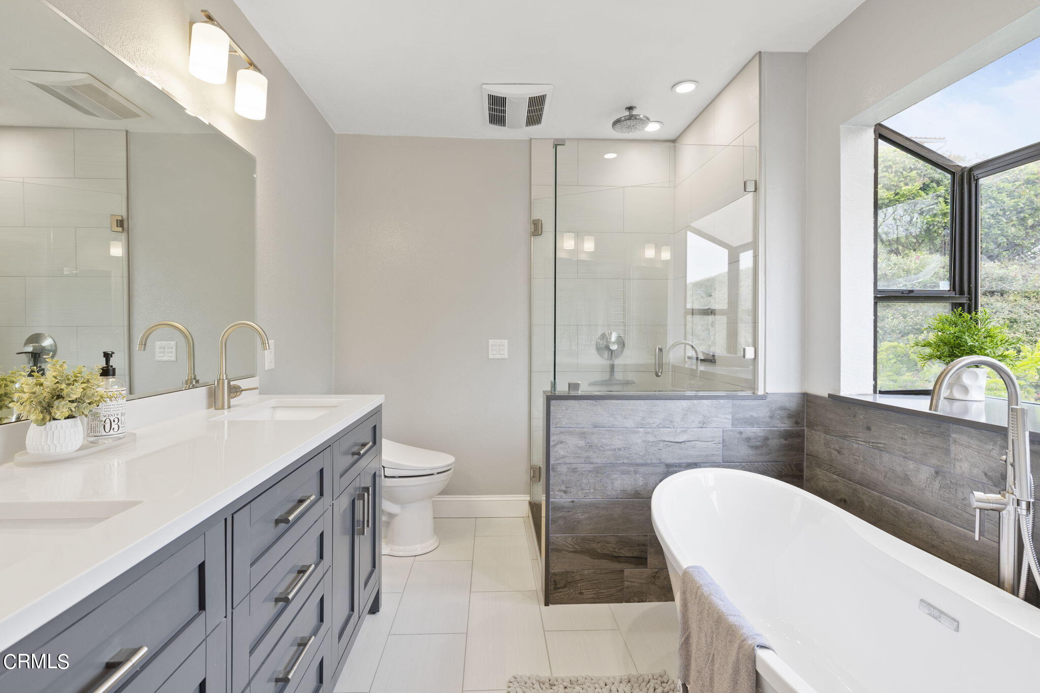 940 Vallecito Drive Ventura, CA 93001 - Photo 32 of 42 a bathroom with a sink a toilet and large mirror