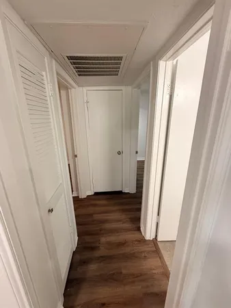 a view of a room with wooden floor and stairs