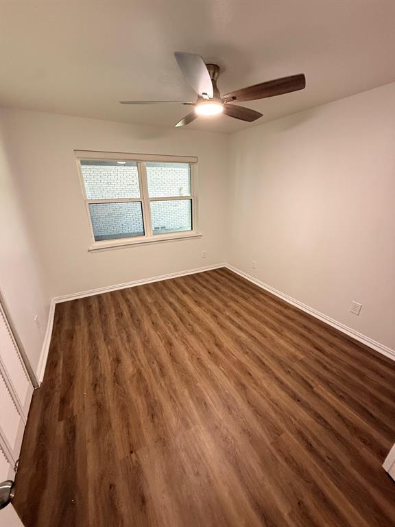 3933 Inwood Road, Unit 1023 Dallas, TX 75209 - Photo 16 of 22 wooden floor in an empty room with a window