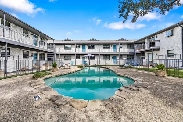 a swimming pool with outdoor seating and yard