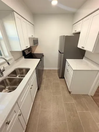 a kitchen with a sink and refrigerator
