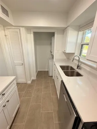 a kitchen with a sink a stove and cabinets