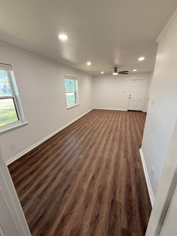 3933 Inwood Road, Unit 1023 Dallas, TX 75209 - Photo 8 of 22 an empty room with wooden floor and windows