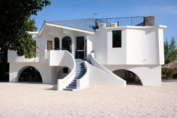 a spacious bedroom with a bed and wooden floor