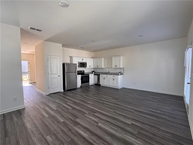 a view of a kitchen with a refrigerator a stove top oven