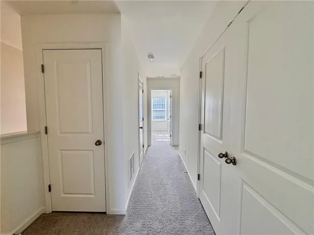 a view of a hallway with a wooden door