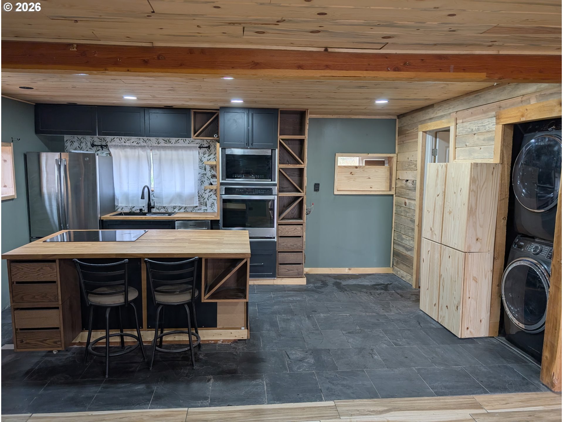 44786 Mission Road Pendleton, OR 97801 - Photo 11 of 19 a kitchen with stainless steel appliances a stove a refrigerator and wooden cabinets