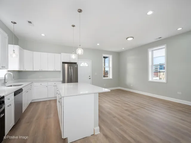 a kitchen with a sink a window and stainless steel appliances