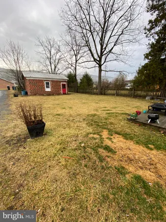 a front view of a house with a yard covered with snow