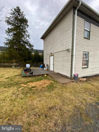 a backyard of a house with barbeque oven and palm trees