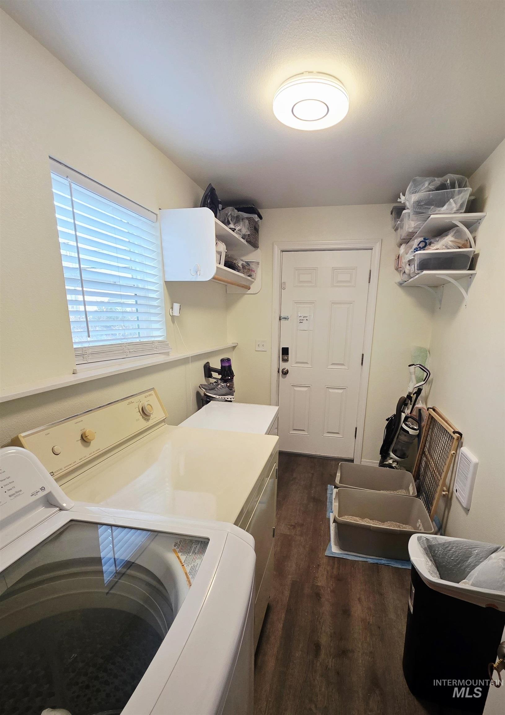409 8th Street Clarkston, WA 99403 - Photo 5 of 23 Laundry area featuring wood-finish flooring, a window with blinds, and overhead lighting
