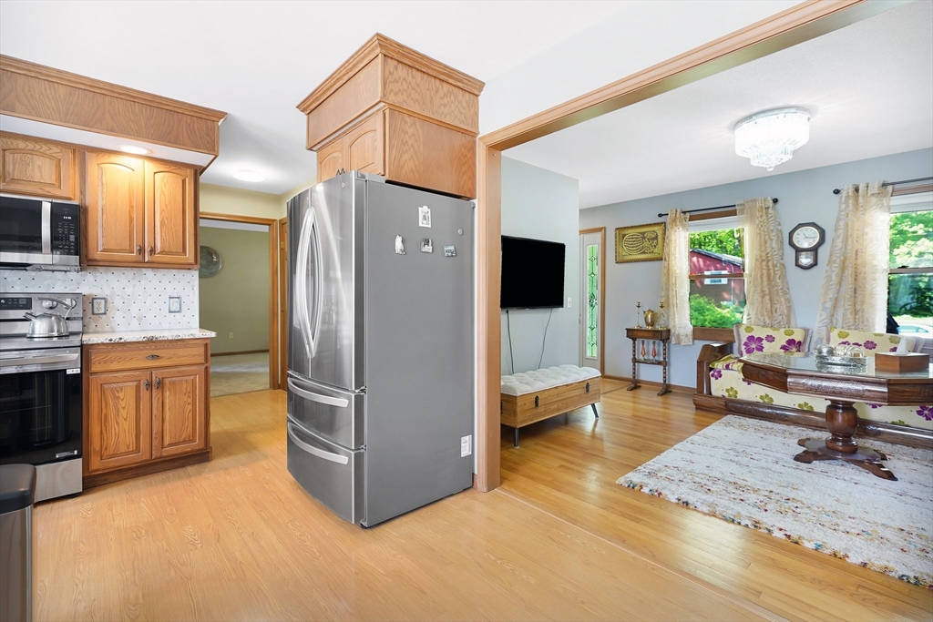 5 Flower Street Springfield, MA 01118 - Photo 19 of 42 a living room with stainless steel appliances kitchen island granite countertop furniture and a kitchen view