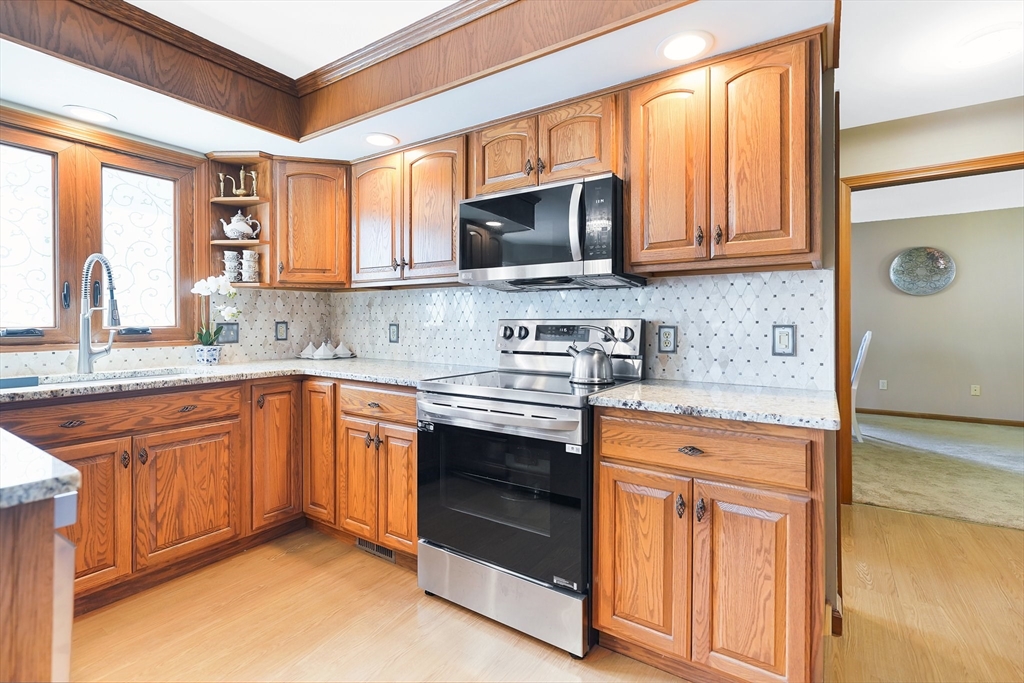 5 Flower Street Springfield, MA 01118 - Photo 20 of 42 a kitchen with stainless steel appliances granite countertop a stove microwave and sink