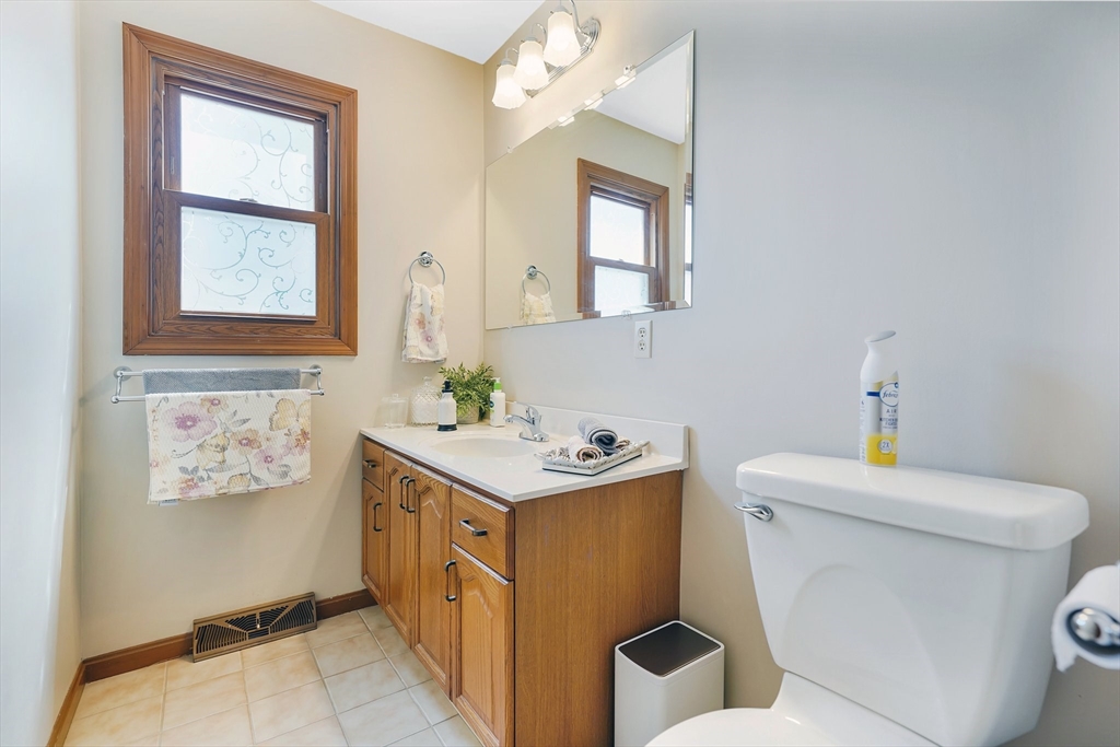5 Flower Street Springfield, MA 01118 - Photo 23 of 42 a bathroom with a toilet sink and mirror