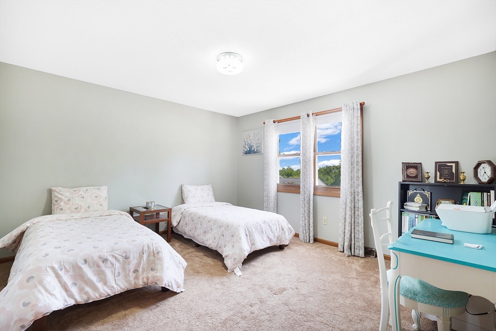 5 Flower Street Springfield, MA 01118 - Photo 36 of 42 a bedroom with two beds and a large window