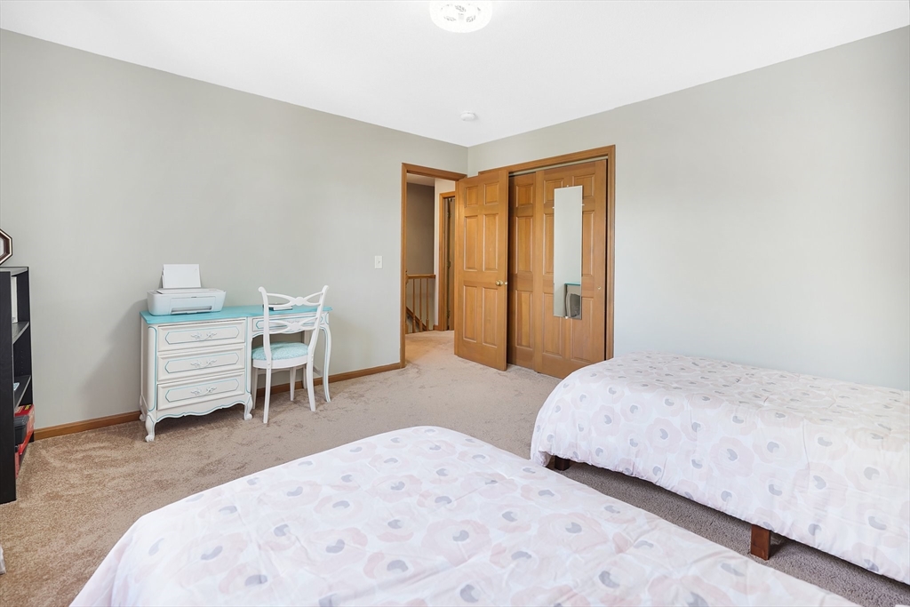 5 Flower Street Springfield, MA 01118 - Photo 37 of 42 a bedroom with a bed and a chair