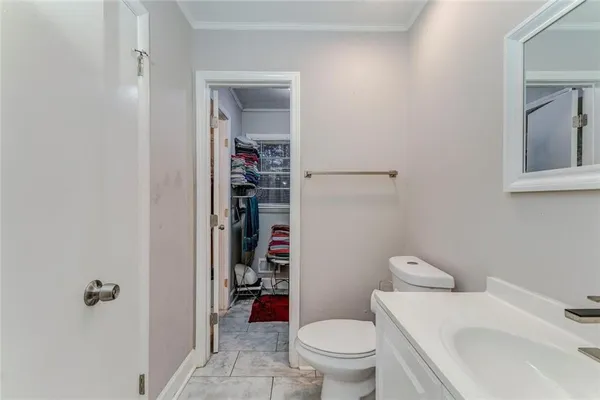 a white toilet sitting next to a bathroom sink