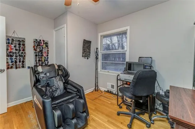 a view of a workspace with furniture and a window