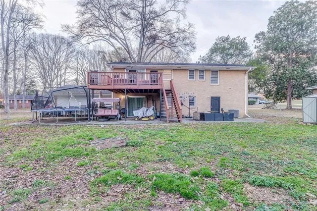 a view of a house with a backyard and a tree