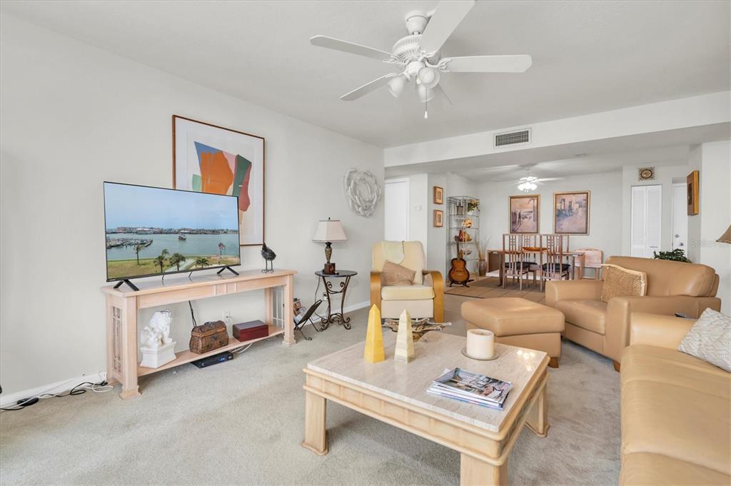 1 Key Capri, Unit 502E Treasure Island, FL 33706 - Photo 11 of 51 a living room with furniture and a chandelier